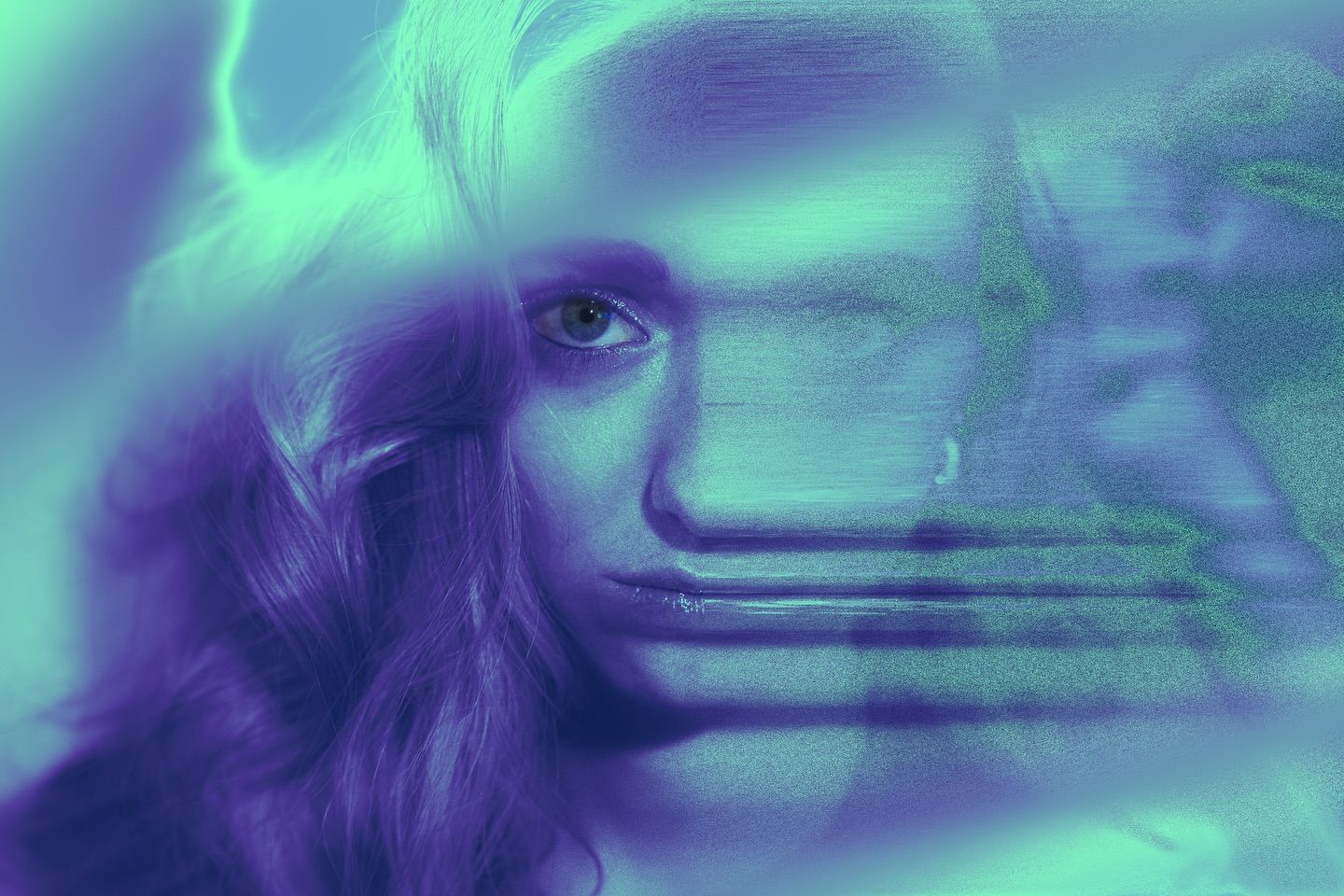 A heavily blurred double-exposure portrait of a woman's face in teal and violet, half sharp and half streaked as if torn apart.